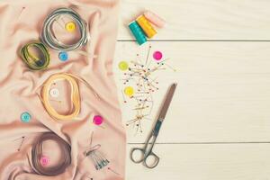 Sewing accessories on wooden table photo