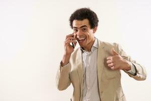 Image of happy businessman talking on the phone and showing thumb up photo