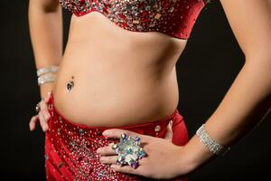 Image of belly dancer performing belly dance on black background photo