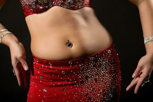 Image of belly dancer performing belly dance on black background photo