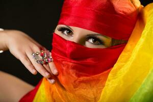 Close up portrait of belly dancer wrapped in veil photo