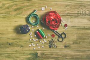 Sewing accessories on wooden table photo