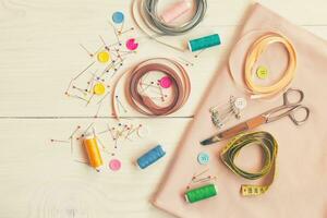 Sewing accessories on wooden table photo