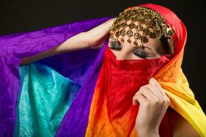 Close up portrait of belly dancer wrapped in veil. photo