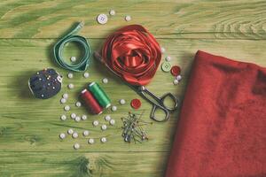 Sewing accessories on wooden table photo