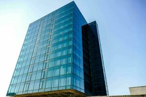 a large glass building with a blue sky in the background photo