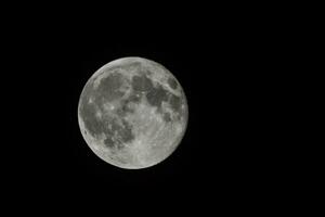 the full moon is seen in the dark sky photo