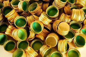 a pile of gold and green plastic caps photo