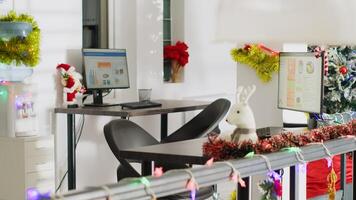 Navidad pino árbol adornar con adornos y Navidad luces en vacío oficina. negocio auditoría Estadísticas en computadora pantallas en Navidad adornar lugar de trabajo con No trabajadores durante invierno fiesta temporada foto