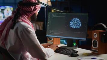 Arab admin using computer to visualize artificial intelligence neural networks made up of interconnected nodes using augmented reality technology. Developer oversees AI systems processing information video