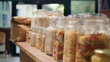 Close up on bulk products in reusable jars used by zero waste eco store to eliminate single use plastics, sustainable lifestyle. Local organic shop storing pantry supplies in nonpolluting packaging. video