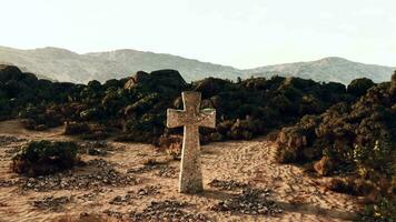 A solitary stone cross standing in the vastness of the desert video