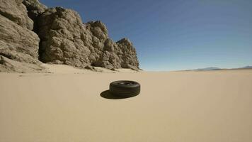 A tire sitting in the middle of a desert video