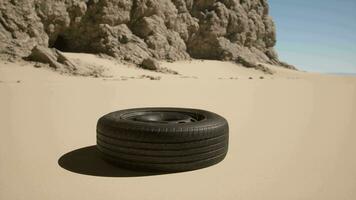 A tire sitting in the middle of a desert video