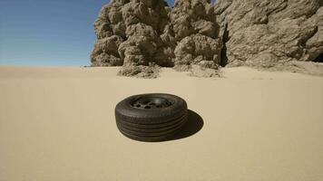 A tire sitting in the middle of a desert video