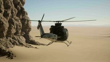 A helicopter flying over a rocky cliff in the desert video