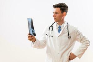 Image of worried  doctor looking at  x ray image photo