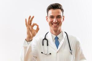 Portrait of young doctor showing ok sign photo