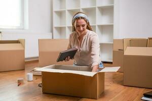 Modern ginger woman with braids moving into new home photo