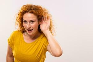 Image of surprised ginger woman listening something photo