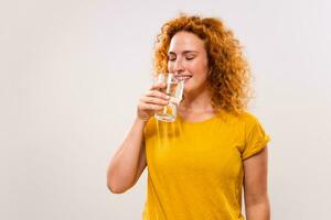 Image of beautiful ginger woman drinking water photo