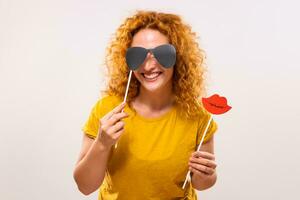 Happy ginger woman is having fun with party props photo