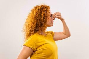 Ginger woman is having pain in sinus photo