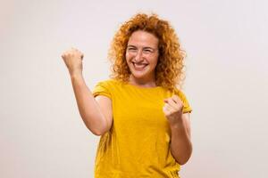 Image of happy successful ginger woman gesturing on gray background photo