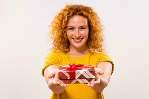 Image of beautiful happy ginger woman holding gift box photo