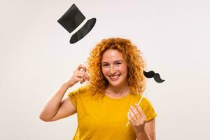 Happy ginger woman is having fun with party props photo