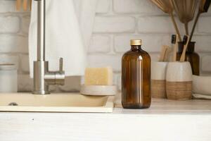 Recycled plastic pump bottle for mockup on white brick wall background near sink photo