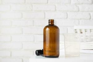 Recycled plastic pump bottle for mockup on white brick wall background photo