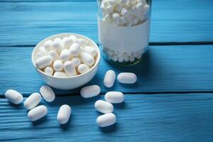 Collagen powder and pills on blue . Top view. AI Generated photo
