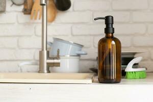 Recycled plastic pump bottle for mockup on white brick wall background near sink photo