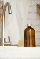 Recycled plastic pump bottle for mockup on white brick wall background near sink photo