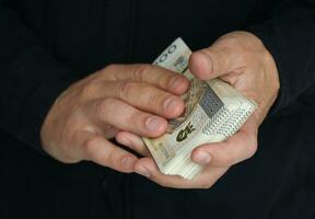 stack of large banknotes in the hands of a man. selective focus photo