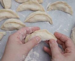 cropped image of the hands of a child who learns to make dumplings with potatoes. selective focus.High quality photo