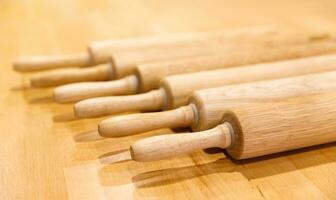 wooden rolling rollers to roll out the dough lie in a row on a wooden table. selective focus.High quality photo