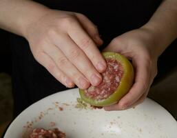 manos de niña quien prepara relleno pimenton, relleno vegetal con picado carne. selectivo foco.alto calidad foto