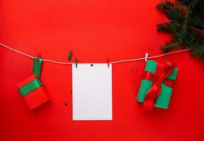 white sheet of paper and a box with a gift on a white string. photo