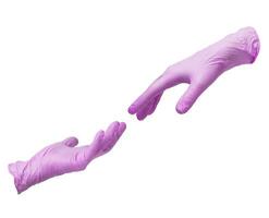 Two hands in sterile pink nitrile gloves reach out to each other. Skin protection during epidemics and quarantine. There is a place for text photo