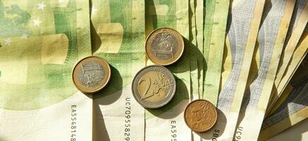 paper banknotes and coins of European currency in sunlight. banner. selective focus. photo