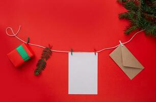 Christmas garland on a red background with green branches. Christmas composition . flat lay photo