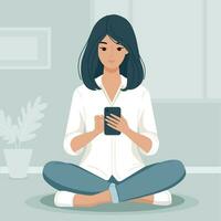 Young woman using mobile phone while sitting on a floor cross-legged with indoor plants and minimal decor in the background. vector