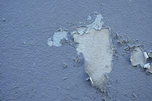 Old cement Wall Peel exterior Background with blue Paint peeling low quality, Cracked Wall photo