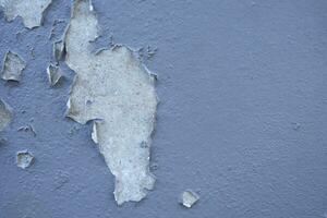 White peeling paint wall surface with moldy.Weathered concrete pattern wall.Old white color painted peeling off moment to do can see raw concrete texture wall.Swelling concrete wall texture. photo