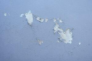 Old cement Wall Peel exterior Background with blue Paint peeling low quality, Cracked Wall photo