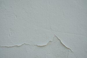 Old cement Wall Peel exterior Background with blue Paint peeling low quality, Cracked Wall photo