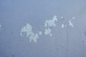 Old cement Wall Peel exterior Background with blue Paint peeling low quality, Cracked Wall photo