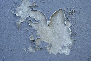 Old cement Wall Peel exterior Background with blue Paint peeling low quality, Cracked Wall photo